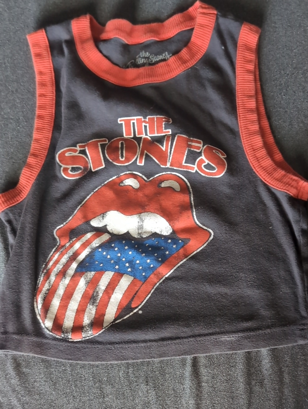 the Rolling Stones Black Crop Tank with Red Trim and Flag Graphic